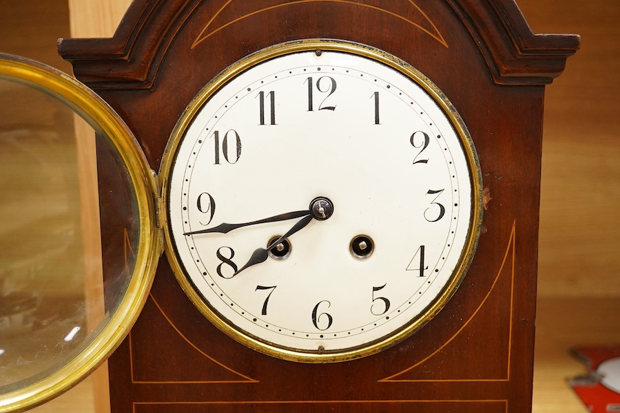 An Edwardian inlaid mahogany mantel clock striking on a coiled gong, 37cm. Condition - fair, untested